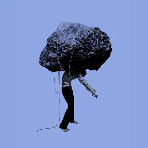 A silhouette of a person carrying a heavy rock.