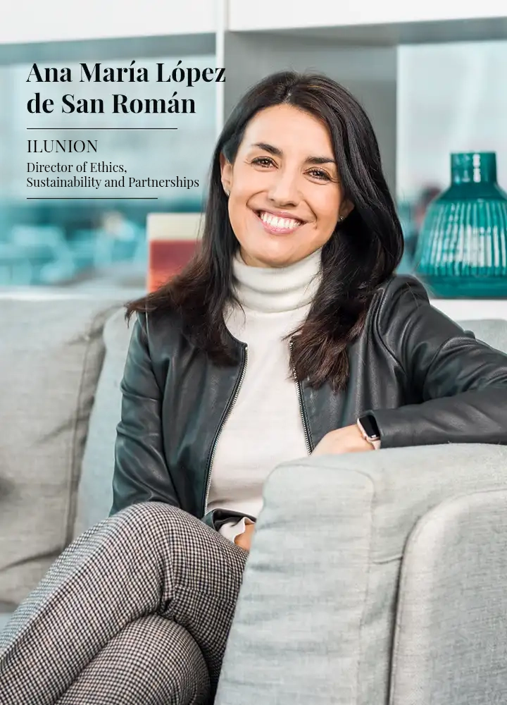 Ana Lopez de San Román smiles while posing on an armchair in the ILUNION Atrium Madrid hotel.
