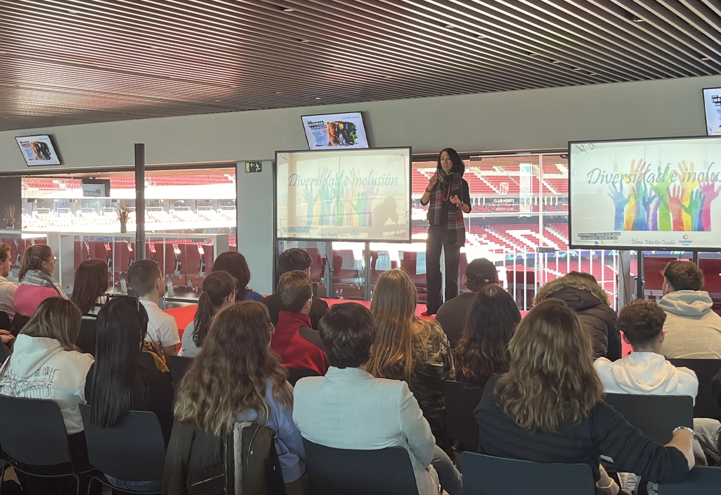 Elena Martín, Director of Sustainability, speaks about the importance of diversity and inclusion at the Cívitas Metropolitano on a sunny day, with the stadium in the background.