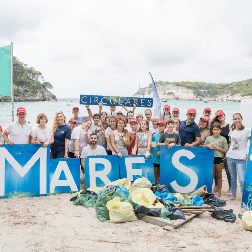 ILUNION Hotels team posing after the beach cleanup at Cala Galdana to promote sustainability