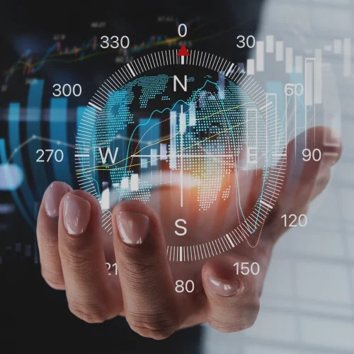 An open hand holds a glowing hologram-shaped digital compass.