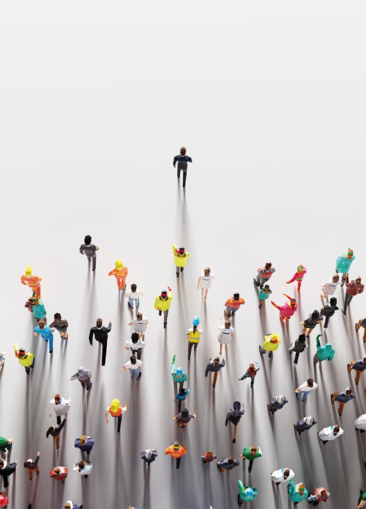 Figuras en miniatura caminan en formación sobre fondo claro, proyectando sombras largas; una figura lidera al grupo, simbolizando diversidad y liderazgo.