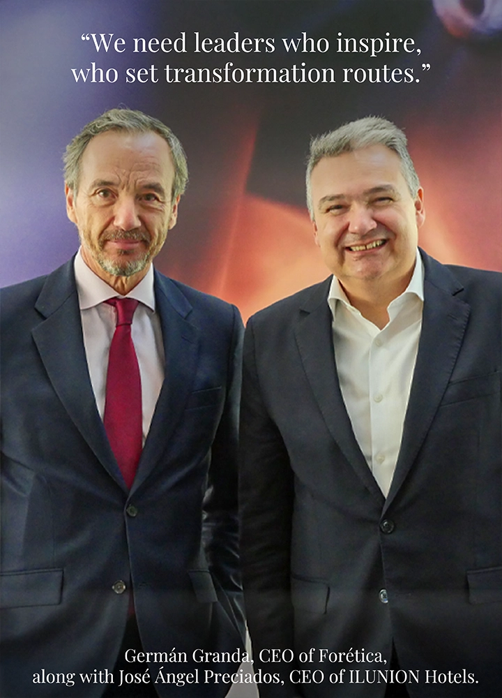 Two men in business suits standing side by side in front of a backdrop with warm tones. Upper text reads: ‘We need leaders who inspire, who set transformation routes.’ Lower text reads: ‘Germán Granda, CEO of Forética, along with José Ángel Preciados, CEO of ILUNION Hotels.’