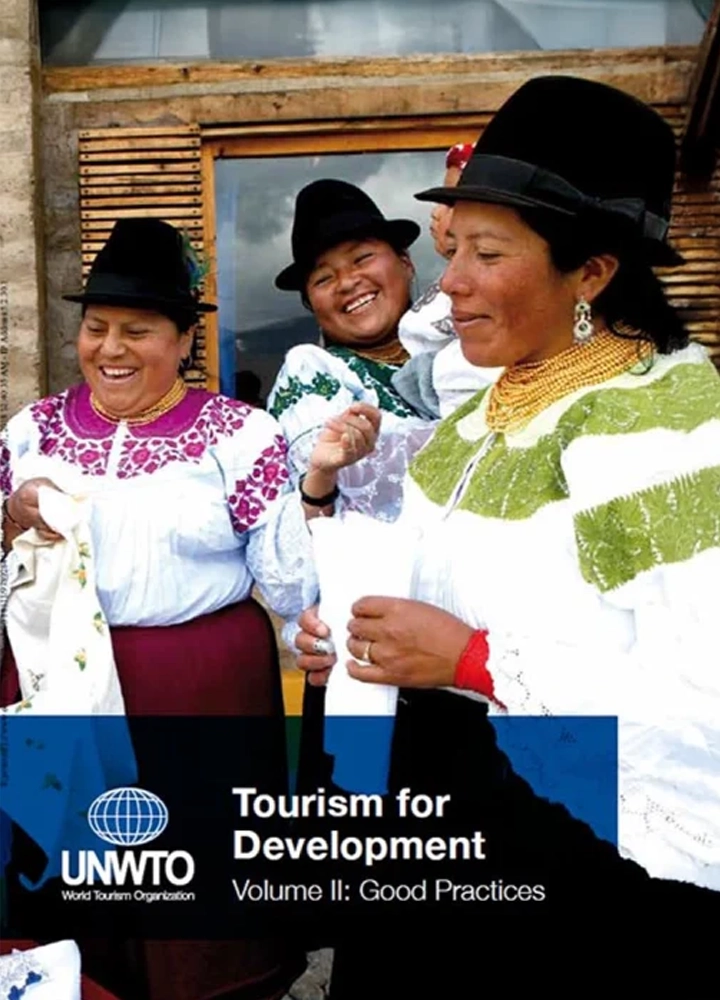 Three women in traditional clothing smile as they take part in an outdoor cultural activity, showcasing joy and community diversity.