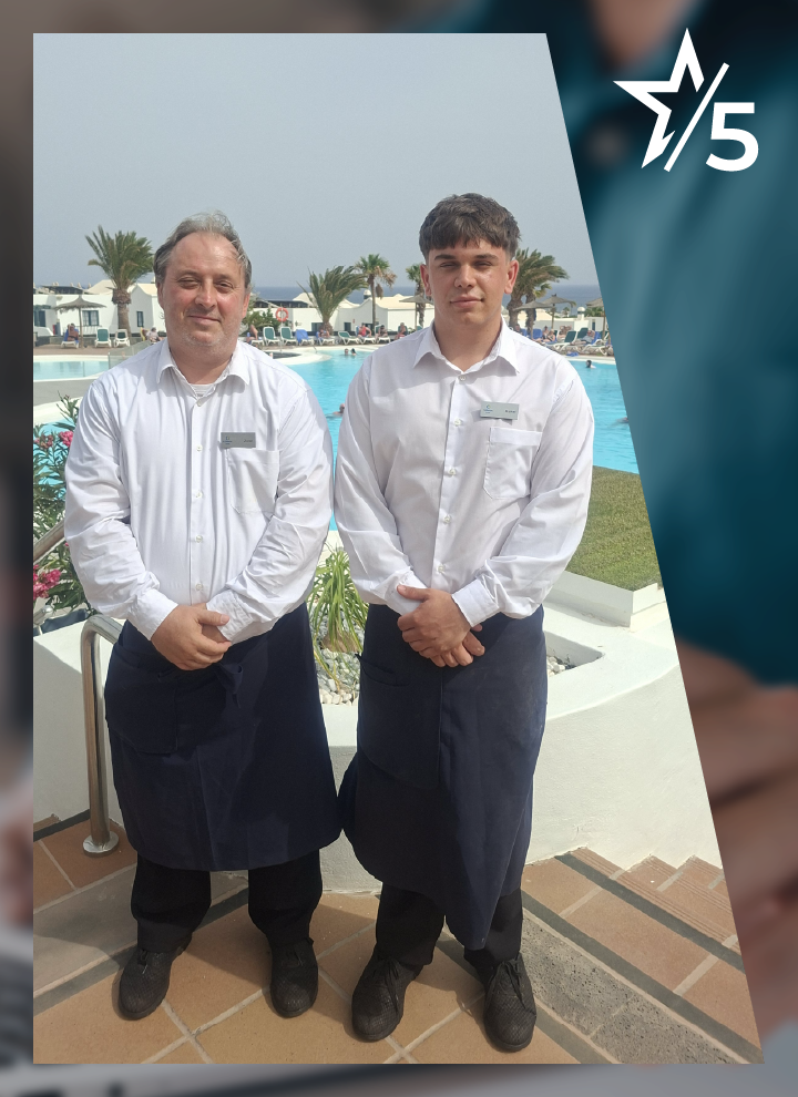 Dos personas con uniforme de hostelería posan junto a una piscina exterior rodeada de palmeras y zonas ajardinadas. En la esquina superior aparece una estrella y el texto “5”.